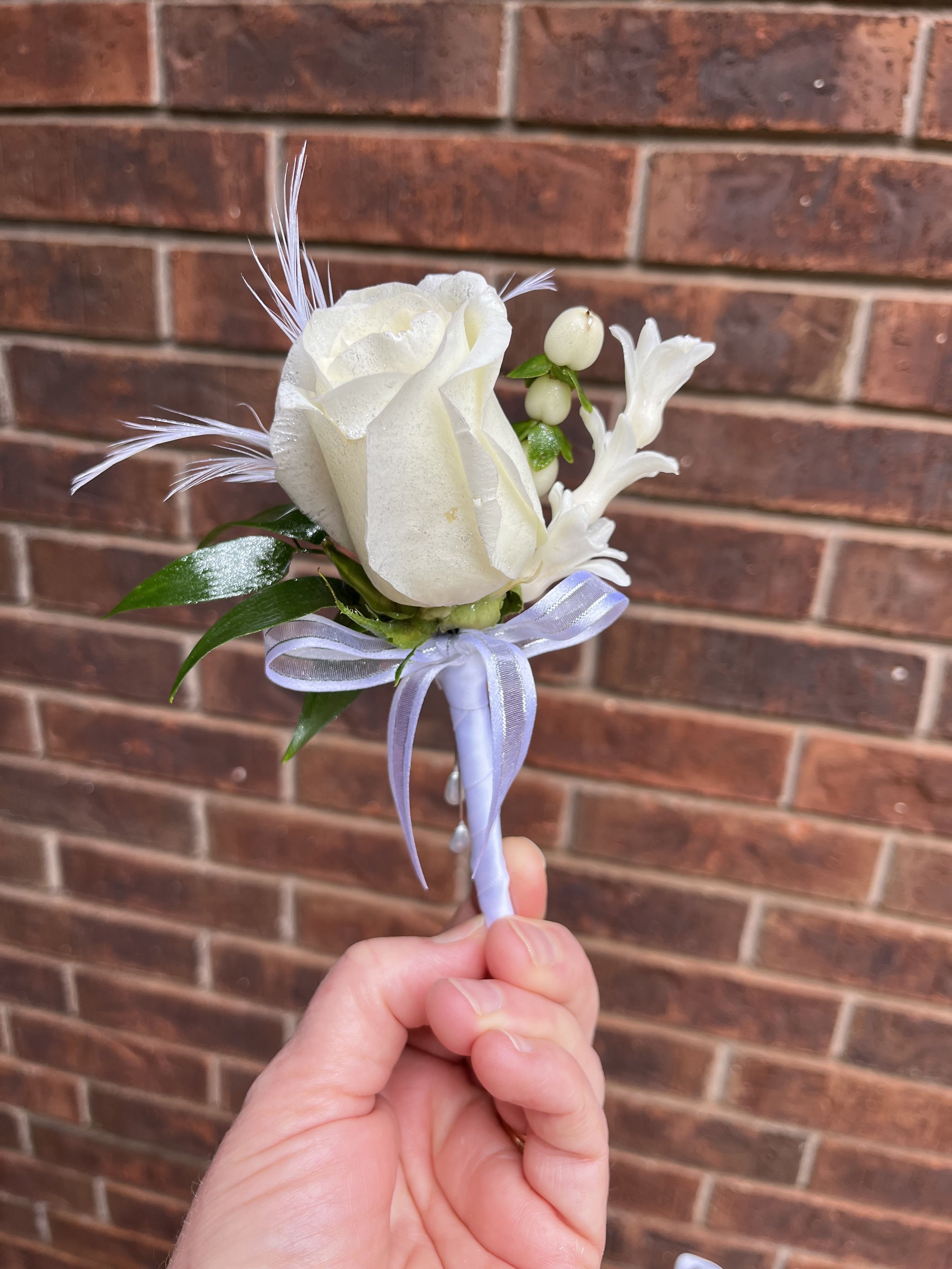 Standard Boutonniere - Made to sit neatly on a lapel for ceremonies, receptions, or photos, this boutonniere is hand-tied for a secure fit and finished with professional stem wrapping. It's an understated way to mark love, romance, or prom night-order to coordinate with bouquets or boutonnieres for a cohesive look.