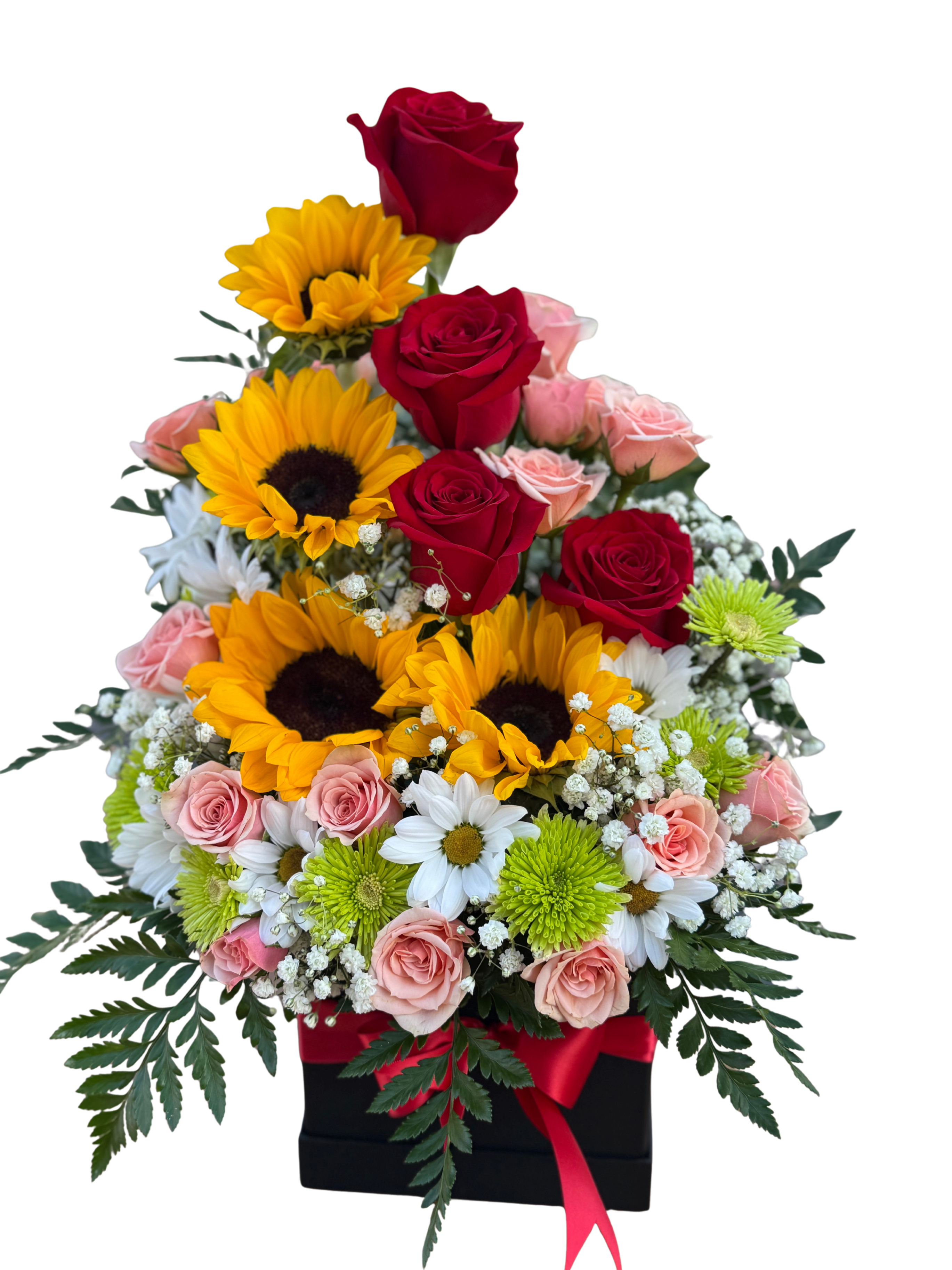 Mixed Flowers - A tiered pyramid of color makes this mixed flower arrangement an unforgettable birthday bouquet or congratulatory gift that feels both festive and refined. Red roses rise at the top to give a romantic, celebratory note while layers of bright yellow sunflowers and soft pink roses create warmth and joy-perfect for birthdays, anniversaries, or to say "congratulations" to someone special.  Carefully arranged white daisies, green button chrysanthemums, and small clusters of baby's breath fill the middle and lower tiers for texture and a light, airy contrast against the saturated blooms. Dark, fern-like foliage spills from the base to frame the composition, all presented in a sleek black gift box tied with a red ribbon for an elegant finish. The compact, pyramid shape gives strong visual height and presence, making the recipient feel truly celebrated.  This arrangement suits a loved one who appreciates bold color and classic florals; she'll feel brightened and noticed the moment the box is opened. Standard care: keep in a cool spot away from direct sunlight, change the water every other day, and trim stems slightly if possible to extend freshness.