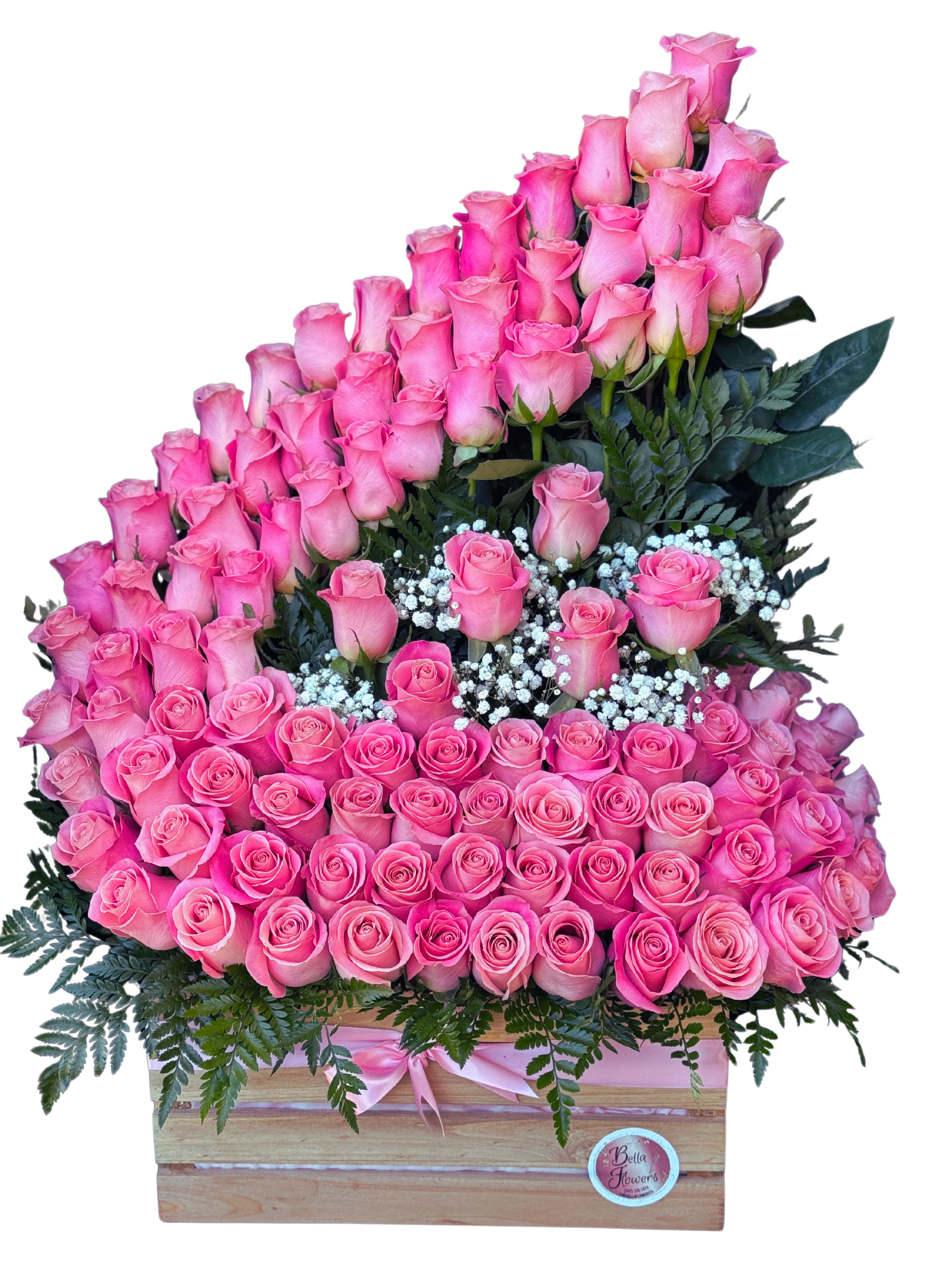 Pink Royal Cascade - A lavish tiered display of pink roses designed to make someone feel deeply adored - perfect as an anniversary bouquet, a Valentine's Day surprise, a Mother's Day gift, or a wedding-related present. This pink floral cascade arranges 100 roses in a formal, abundant silhouette that rises from a wooden box, giving the recipient an immediate impression of luxury and heartfelt celebration.  The arrangement features 100 pink roses clustered across the front and built into a peaked, tiered top, with tiny white baby's breath tucked through the center and dark green foliage framing the blooms for contrast. Presented in a natural wooden box and finished with a pink ribbon and a round logo sticker, the piece reads feminine and elegant in shades of pink, white, and green. Box dimensions and care: keep flowers in a cool place away from direct sunlight, refresh water daily if applicable, and trim stems slightly if you receive the arrangement unpacked to extend bloom life.  This is the kind of gift that makes the person you're thinking of feel truly celebrated - order early for holiday delivery windows and special dates to ensure availability.