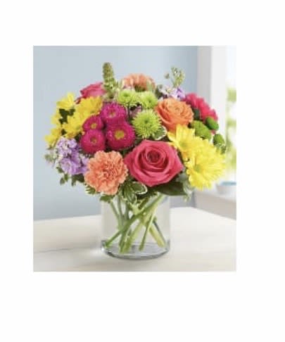 Sunset Garden Glow - A vibrant and uplifting arrangement bursting with fresh seasonal blooms in warm sunset tones. Featuring a beautiful mix of yellows, oranges, pinks, and soft greens, this design is artfully arranged in a clear glass vase for a clean, modern look. Perfect for brightening any space or sending a joyful, heartfelt surprise.
