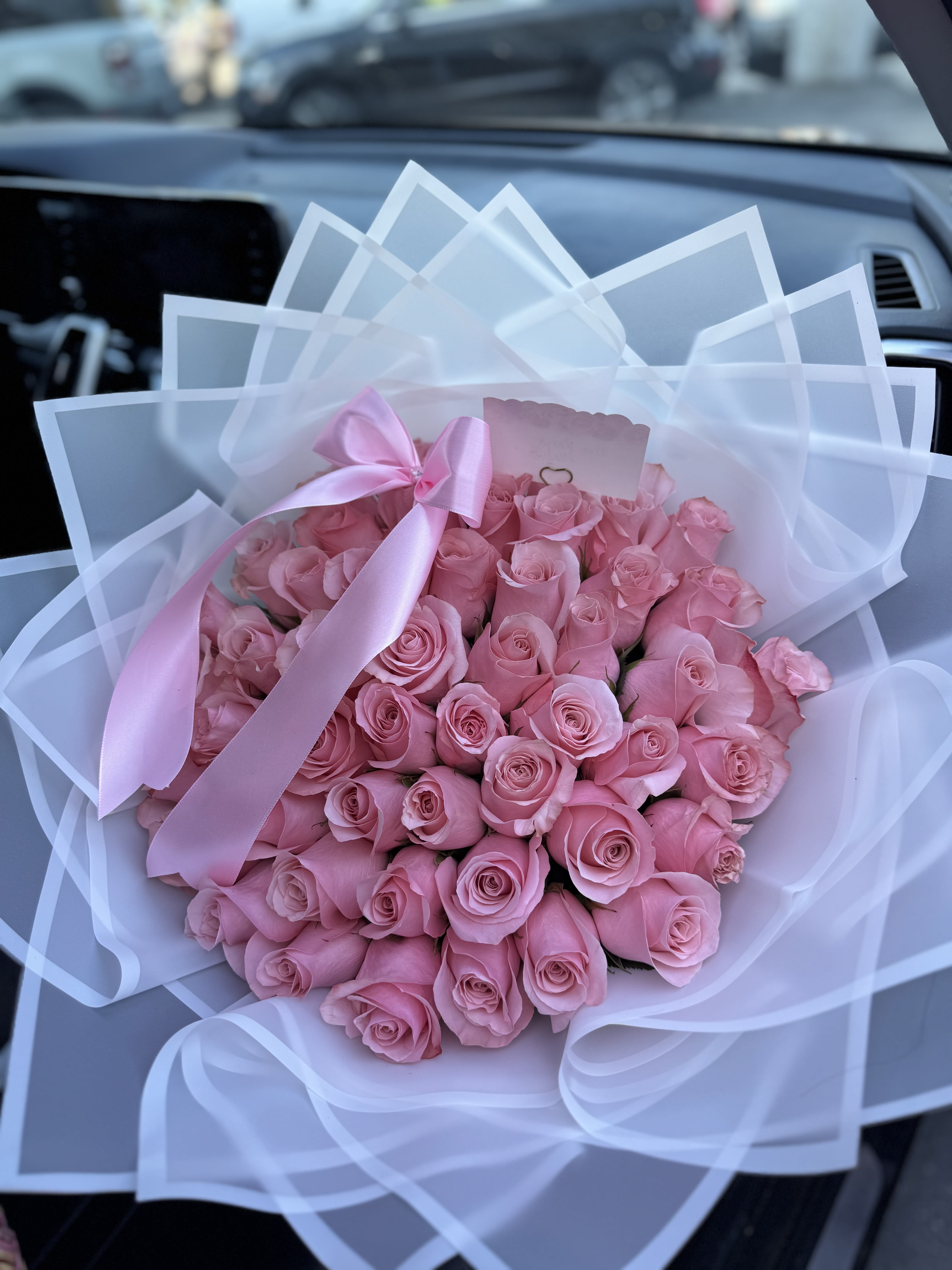 Light Pink Ramo Buchon - 50, 75 &amp; 100ct  - Light Pink Rose Bouquet  Rose Count: Standard (50 Roses) to deluxe (75 roses).  (if you like a different popular option which includes white, red, yellow, sunflowers, or multi-color combinations, please see other products)  Wrapping: The bouquet is finished in stylish, specialized waterproof wrapping, which you can choose from black, white, pink,  brown, purple, blue, green, yellow, orange among others, please call us if needed to discuss wrapper color.   Add-ons under Personalization Section Personalized touches available include diamond pins in the rose centers, butterflies, or custom banners. Bouquets are frequently paired with extras like teddy bears, "I Love You" balloons, or gourmet chocolate boxes.   BOUQUET COMES ONLY AS ROSES AND WRAPPING, accessories like ribbon, vase, teddy bears etc, have an extra cost, please add them under Accessories 