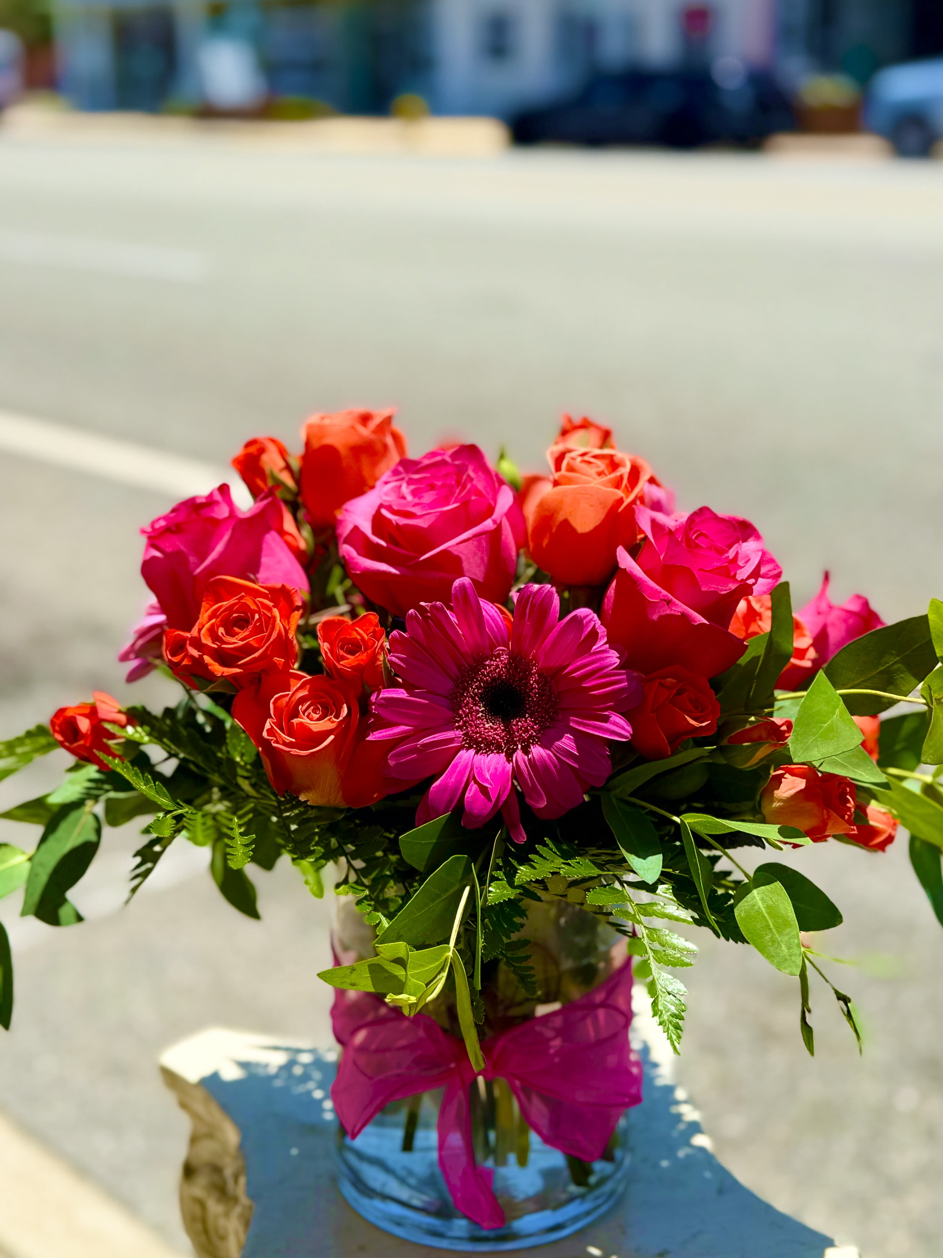 Electrical Love - Hot pink roses electric orange spray roses and popping pink Gerbers designed in a lush cylinder. 