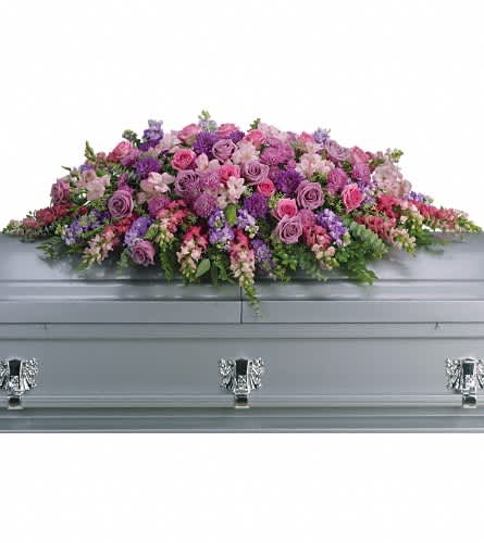Lavender Tribute Casket Spray - Like a heartfelt embrace this beautiful casket spray delivers comfort and love in an extraordinary way. A wonderful array of lavender and pink flowers with just the right amount of greenery is a lovely way to pay tribute to someone who will always be with you in heart mind and spirit. Lovely lavender and pink roses snapdragons alstroemeria chrysanthemums fern eucalyptus and more create this tribute that is overflowing with grace and love.Approximately 51" W x 22" H Orientation: N/A As Shown : T235-2A
