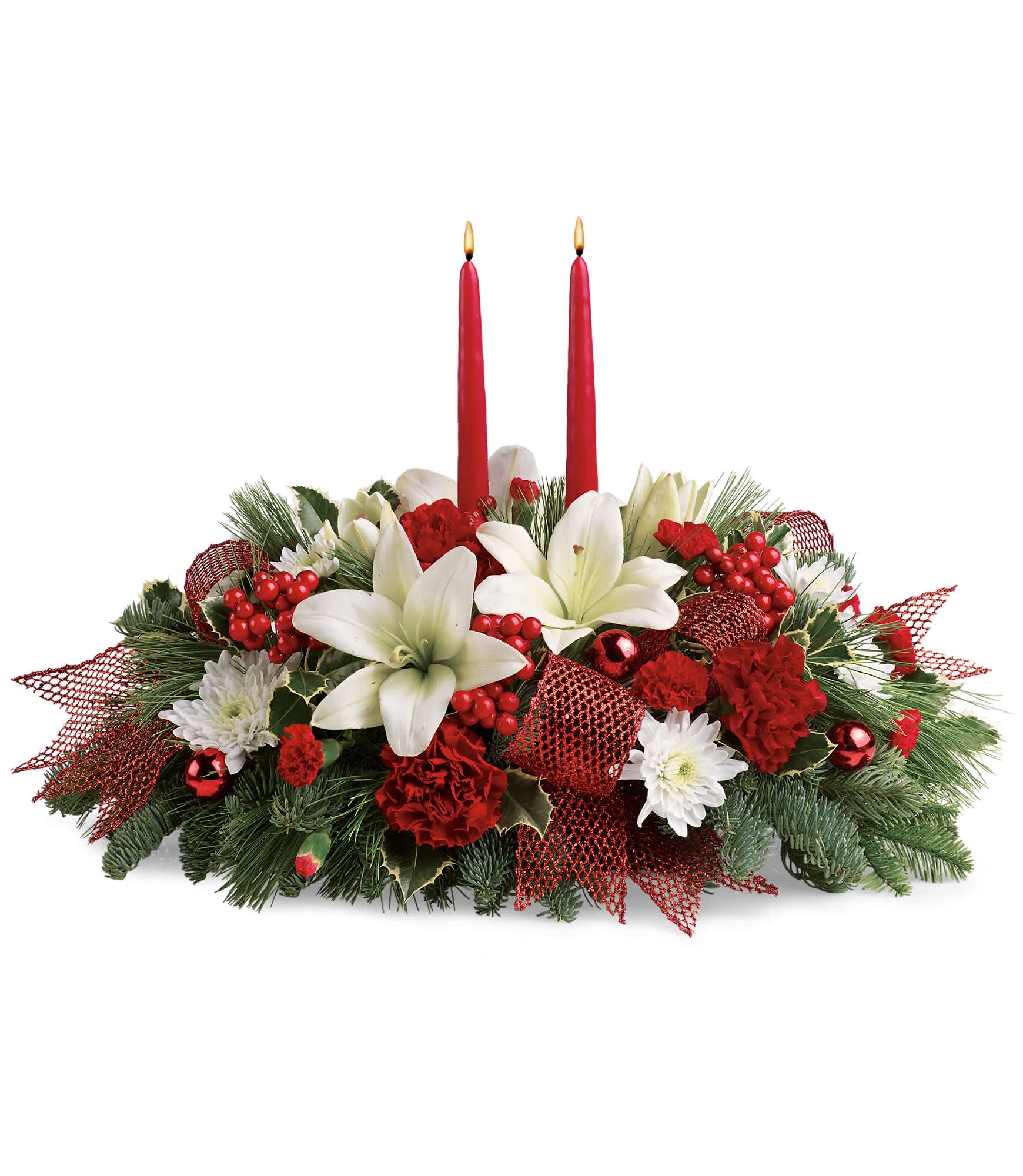Yuletide Magic Centerpiece - White asiatic lilies, red carnations, red miniature carnations and white cushion spray chrysanthemums are accented with noble fir, white pine, variegated holly, berries and festive red ribbon. Approximately 21 1/2" W x 15" H. TWR12-3A