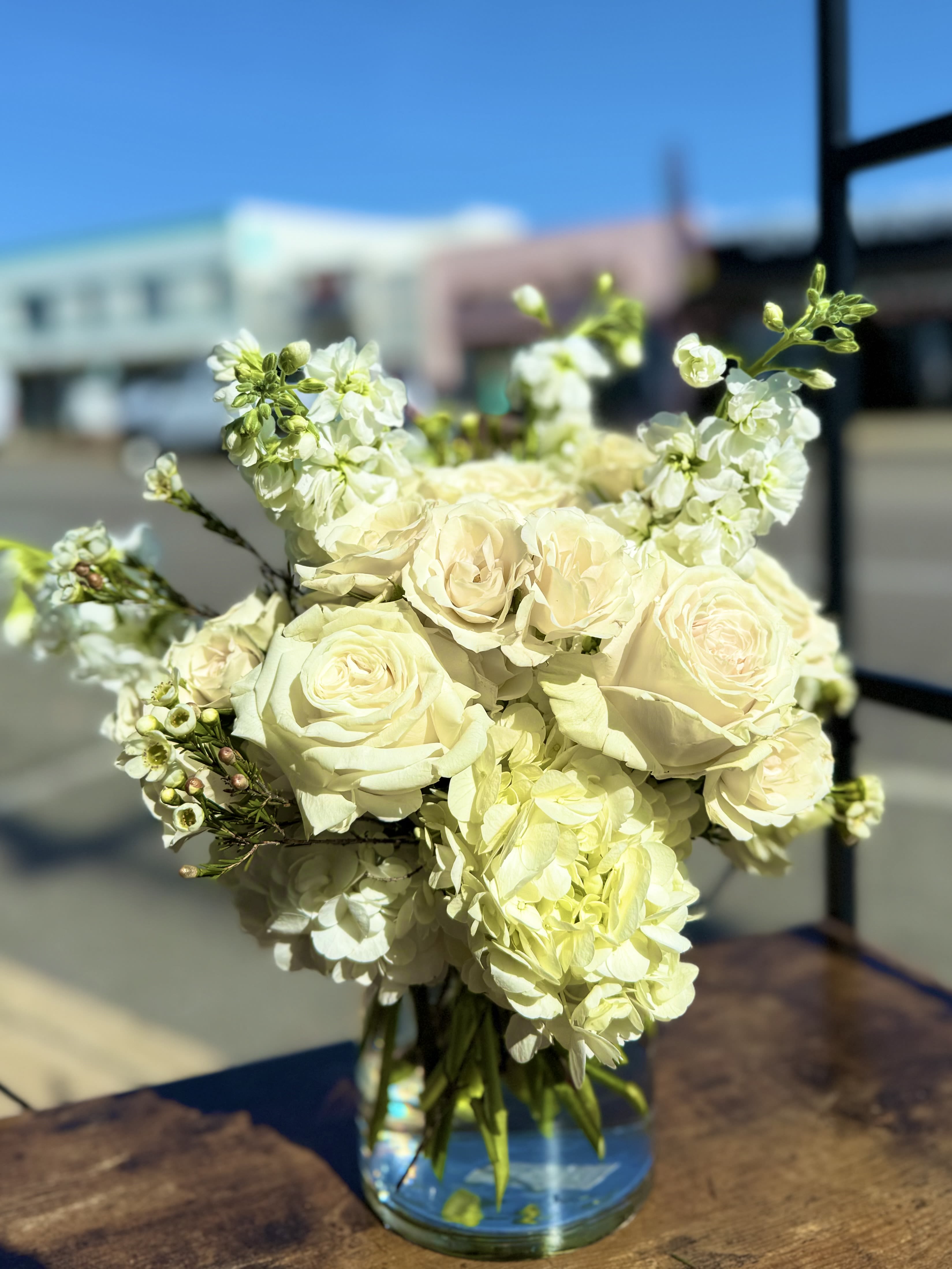 Floating on a cloud  - Creamy white roses fragrant stock lush hydrangeas elegantly designed in a cylinder.