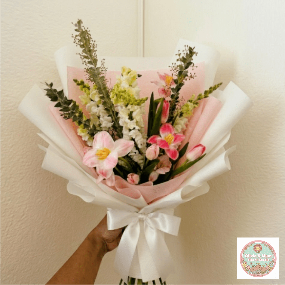 Spring Romance - Fresh, vibrant, and full of hope—Spring Romance celebrates the beauty of a love that continues to bloom. The architectural reach of white snapdragons adds a noble height to the romantic curve of seasonal pink tulips.  This seasonal bouquet features:  Pink Tulips  White Snapdragons  Lush Garden Greens
