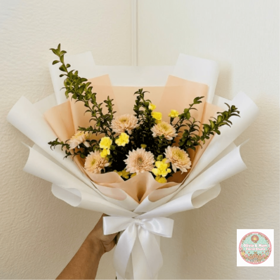 Citrus Squeeze - Zesty, refreshing, and bright—Citrus Squeeze brings a boost of energy to any birthday. The clean lines of yellow carnations and peach mums create a structured, cheerful look that feels both fun and modern.  This seasonal bouquet features:  Yellow Mini Carnations  Peach Mums  Fresh Boxwood  Garden Greens  Presentation: Expertly wrapped in our signature textured paper and tied with satin ribbon. Prefer a vase? Add one to your cart to complete the look.  Personal Touch: We’ll include a custom card message with every order. You’ll be able to write your message at checkout.  Please Note: All flowers are subject to seasonal availability. If a specific bloom isn’t available, our designers will thoughtfully substitute with flowers in a similar shape, style, and color.  Standard size shown. Vase upgrade is optional.   Floral Care Guide  Your arrangement arrives in our signature "double wrap" and is nestled in a protective box. While the stems are secured with a wet wrap for transit they are ready for a full drink!   Unpack: Gently lift the bouquet from the box. Remove the plastic bag and wet towel from the stems. Trim &amp; Hydrate: Trim 1/2" off stems at an angle and place in a clean vase with cool water. Refreshed: Change water daily for a long-lasting bloom.  