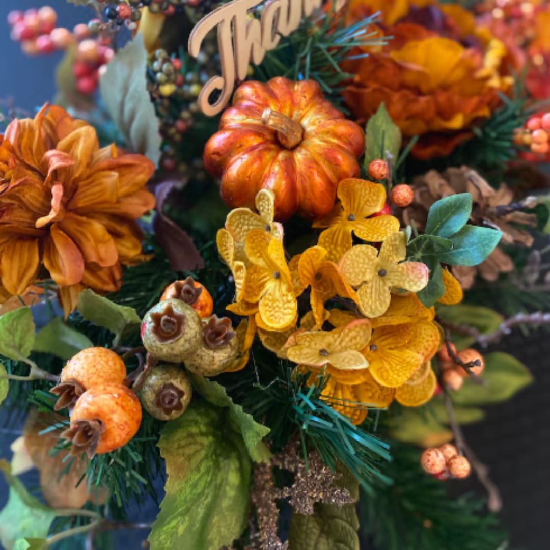 Autumn floral arrangement with orange blooms and berries