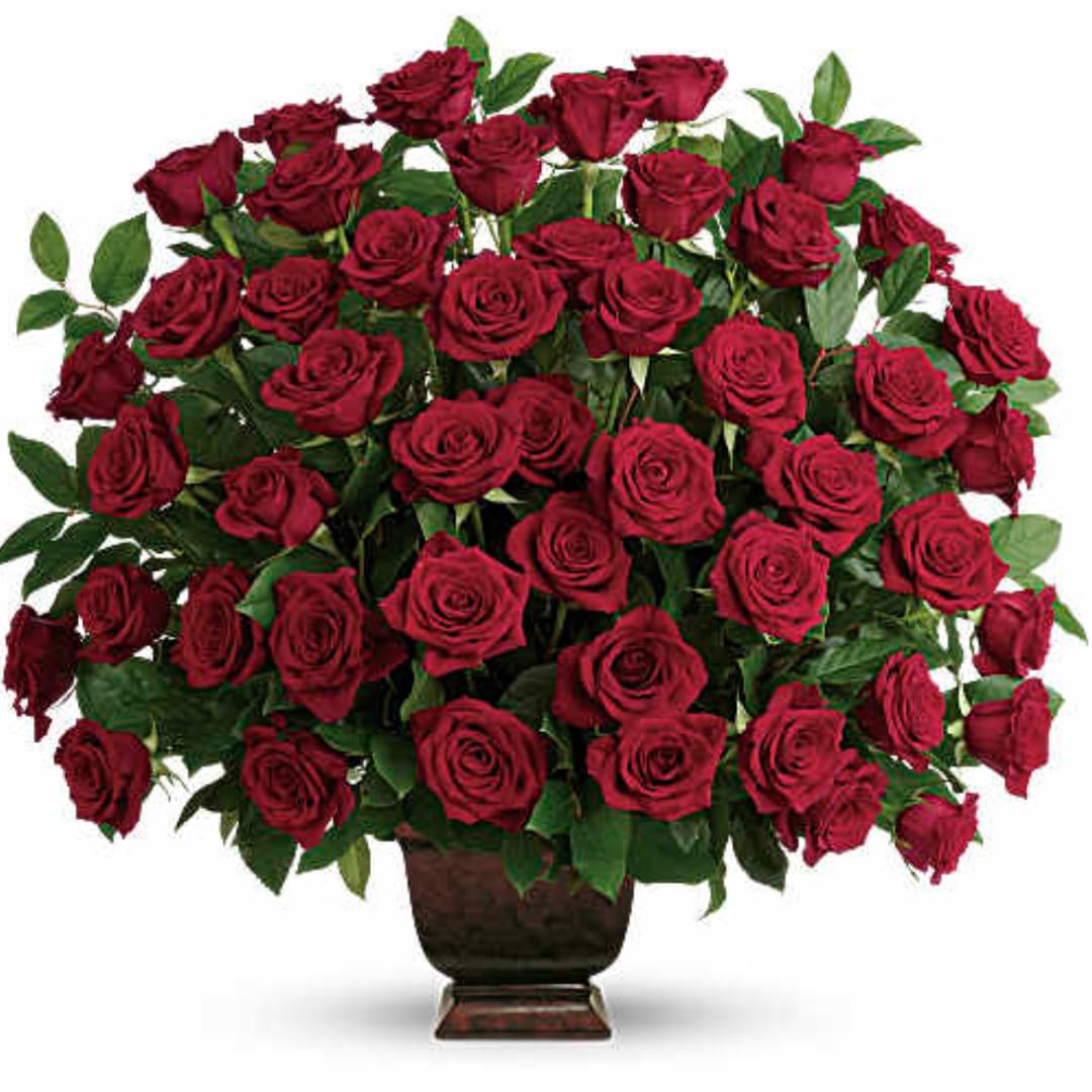 Large bouquet of red roses in a dark vase