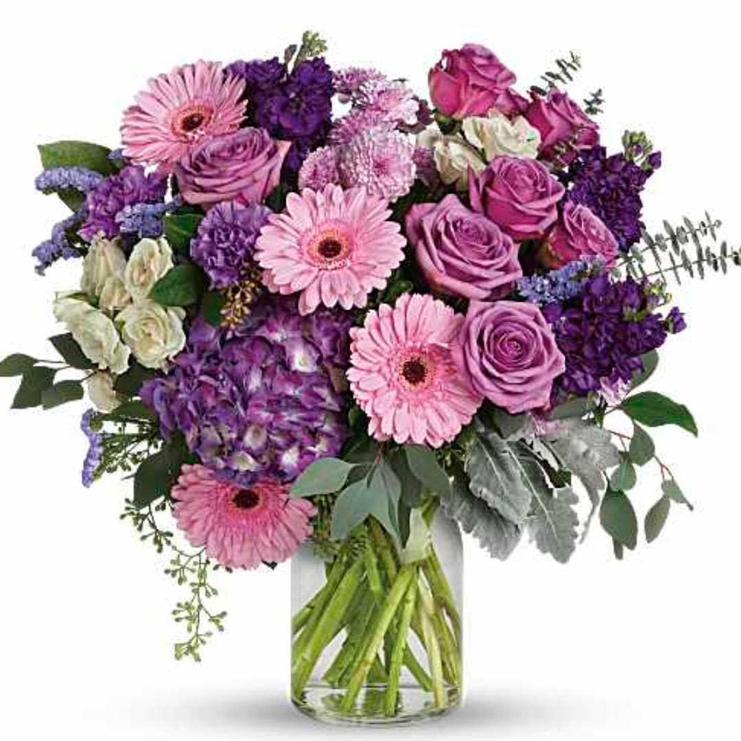 Pink and purple mixed bouquet in a clear glass vase