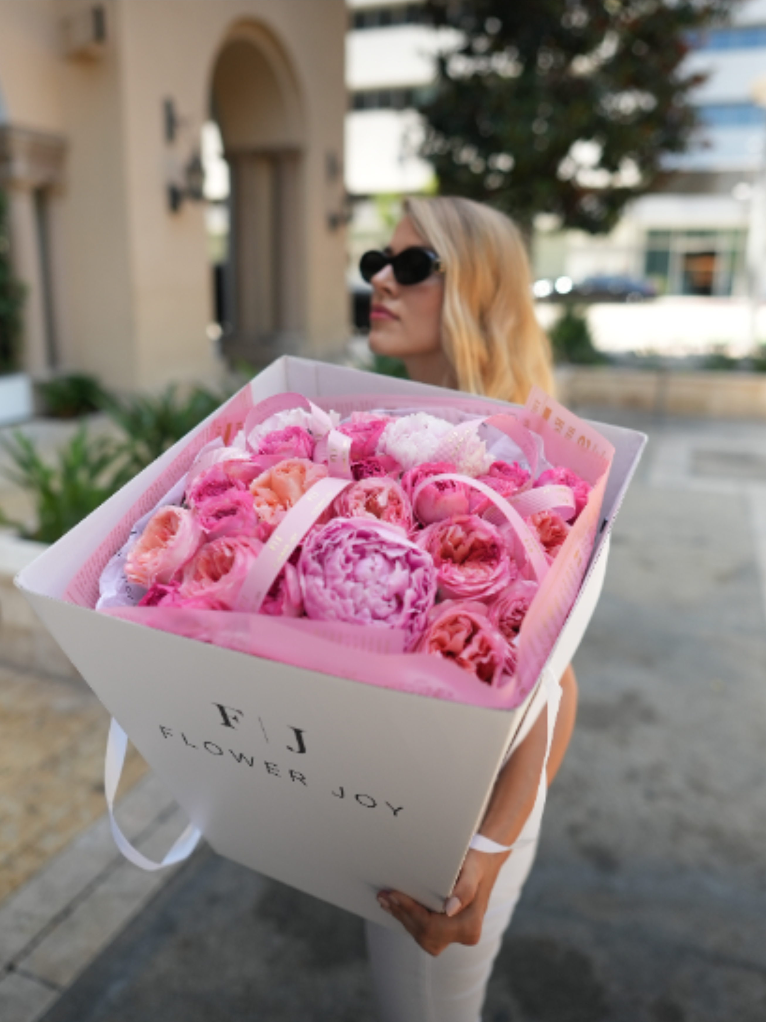 Pink Peony Luxe Box - A romantic arrangement filled with lush pink peonies and garden-style blooms in soft blush, coral, and vibrant rose tones. Presented in the signature Flower Joy box with delicate branded ribbons, this luxurious design makes a beautiful gift for birthdays, anniversaries, celebrations, romantic surprises, or any moment worth making unforgettable.