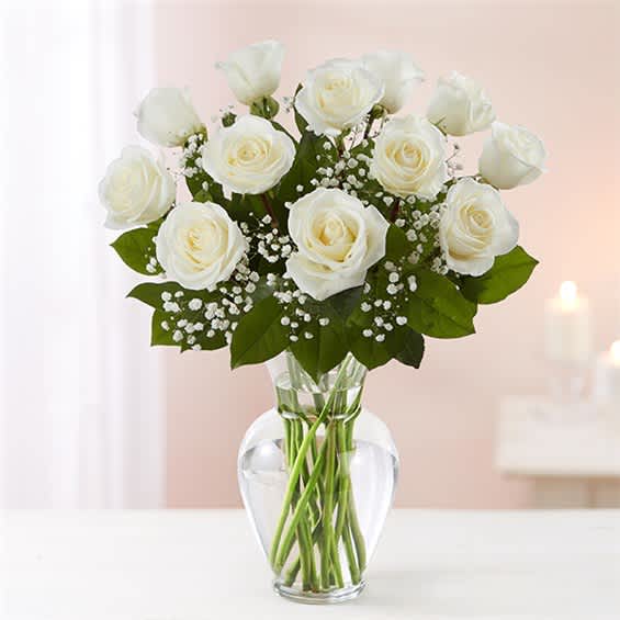 White roses arranged in a clear glass vase