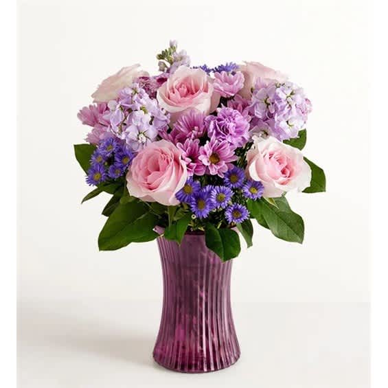 Pink and purple flower arrangement in a tall purple vase