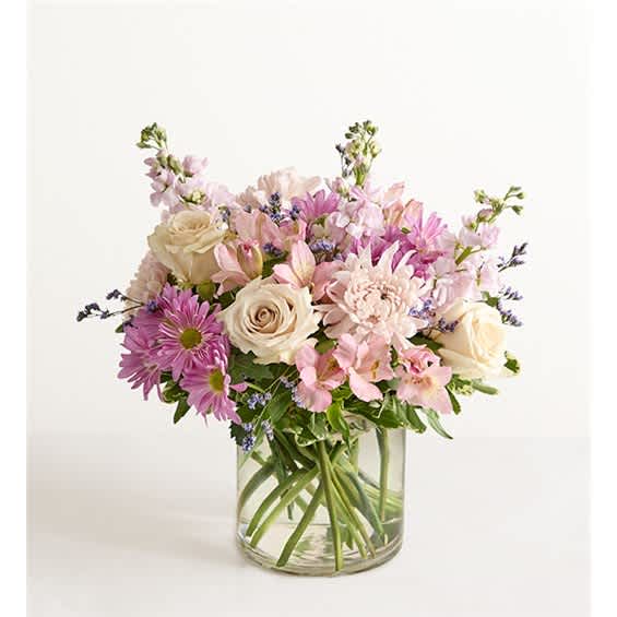 Bouquet of pink and cream flowers in a clear glass vase