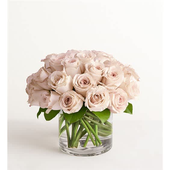 Pale pink roses arranged in a clear glass vase