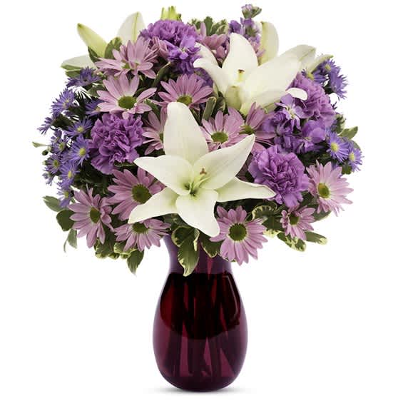 Bouquet of pink and purple flowers in a purple glass vase