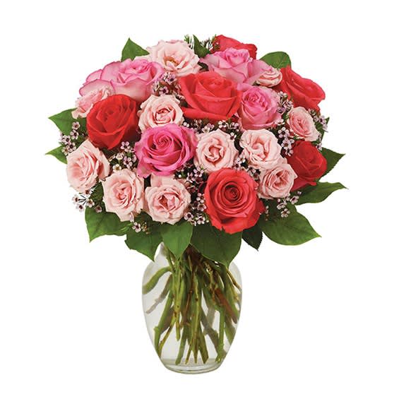 Bouquet of pink and red roses in a clear glass vase