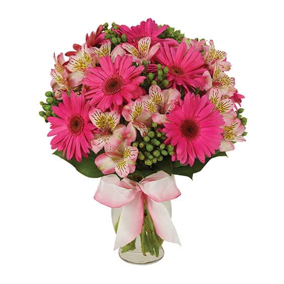 Pink gerbera daisies and alstroemeria in a glass vase with a pink ribbon