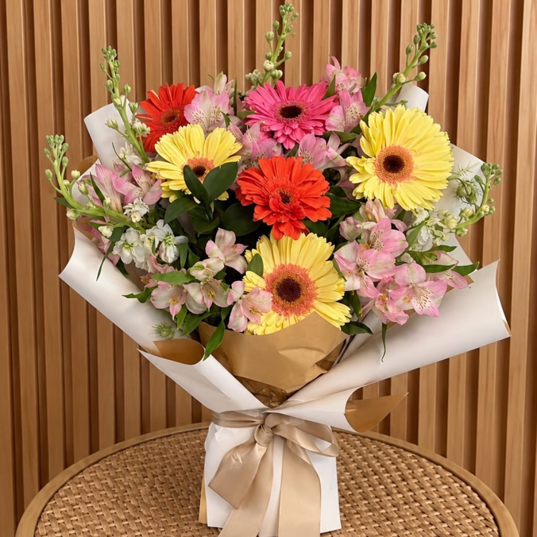 Bouquet of yellow, pink, and orange gerbera daisies with alstroemeria