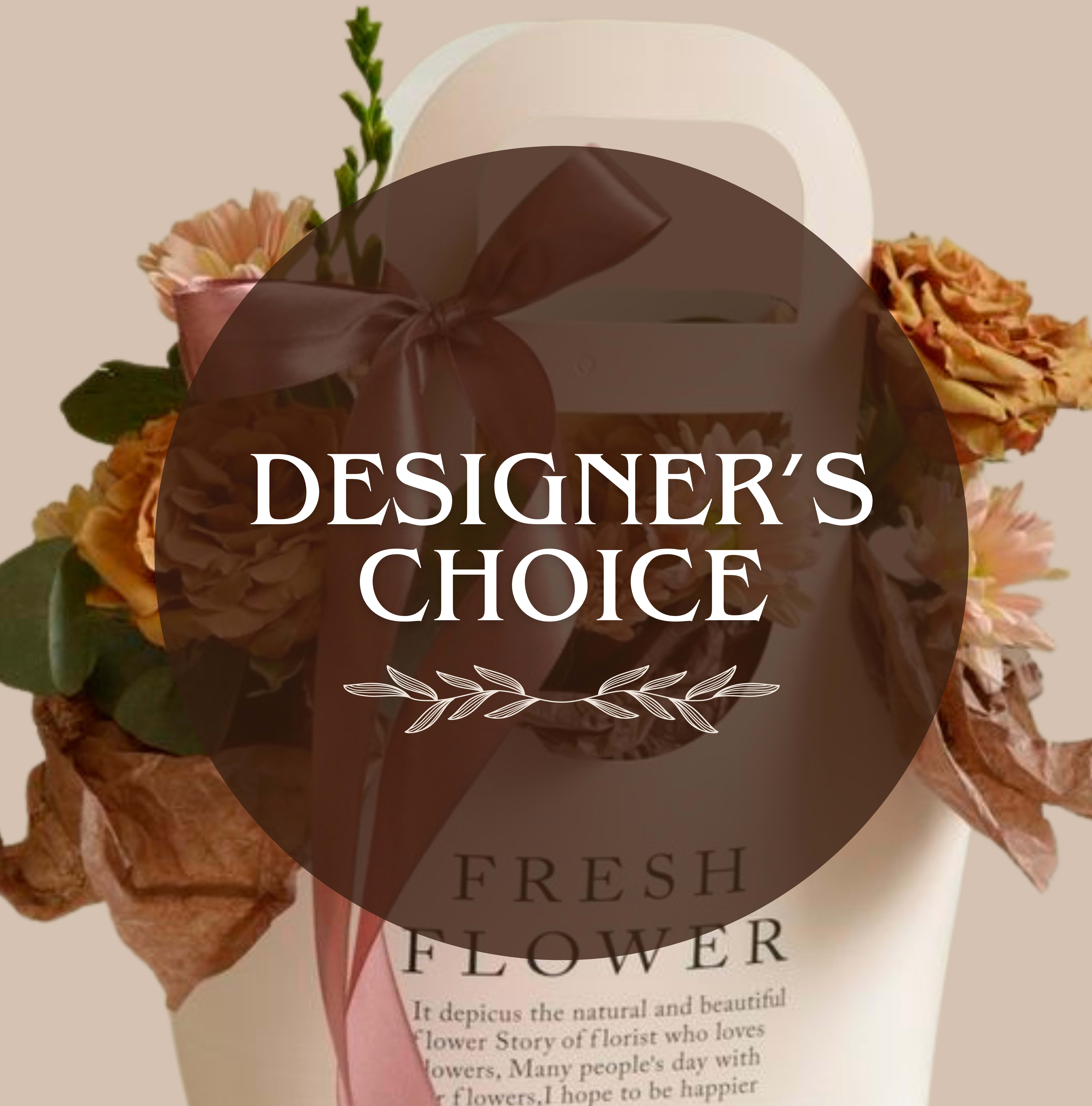 Designer's Choice Carrier - Mixed flower arranged around a kraft bag make this small floral carrier an instantly charming choice for a birthday bouquet, a thank-you gift, or a casual celebration. The compact, gift-box presentation reads as both thoughtful and stylish-perfect for the person you want to surprise with something romantic but not overdone. The soft pink and peach palette with touches of white and green gives a gentle, uplifting impression that will make the recipient feel noticed and cared for.  This Designer's Choice Carrier features mixed colored blooms nestled with soft green foliage and crinkled brown paper accents for added texture, all presented in a kraft bag with a wide satin ribbon that drapes gracefully at the front. The arrangement is intentionally small and decorative, ideal for bedside tables, desks, or a doorstep surprise. Order as shown for an immediate, effortless gift-ready presentation; no special care beyond fresh water from the florist is required for the short-term enjoyment typical of boxed arrangements.