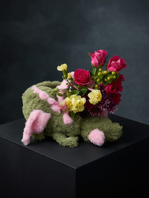 Bouquet arranged in a plush bunny-shaped container with pink and yellow flowers
