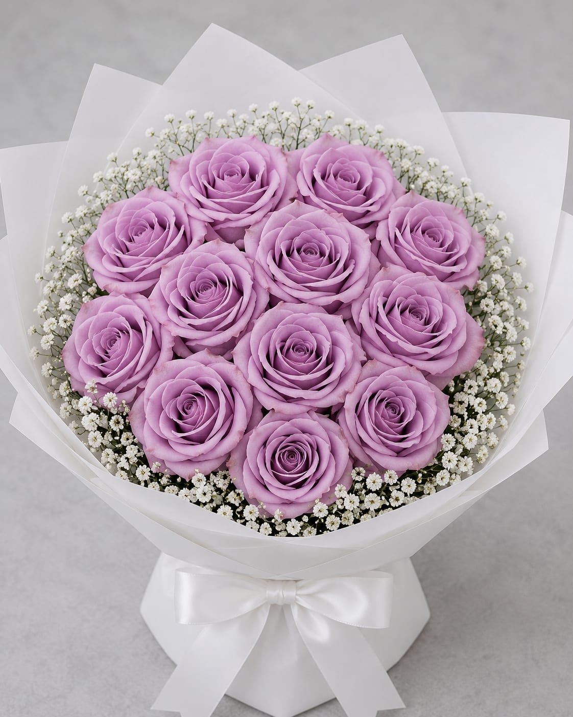Blue Dreams Rose Bouquet - Blue Dreams Rose Bouquet  Delicate, enchanting, and effortlessly elegant, this bouquet features Blue Dreams roses, admired for their soft lavender hues and dreamy, romantic appearance. Their unique pastel coloring creates a sense of serenity and sophistication, making them a truly captivating choice for any occasion.  Blue Dreams roses symbolize enchantment, admiration, grace, and the beauty of dreams coming true. Their gentle lavender tones evoke feelings of tranquility, wonder, and heartfelt affection, making them a thoughtful gift for celebrating meaningful moments and special connections.  Known for their luxurious blooms, graceful petal formation, and refined beauty, Blue Dreams roses bring a touch of elegance and charm to any space. Their distinctive color and timeless appeal make this bouquet perfect for creating memorable impressions and expressing sincere emotions.   Symbolism: Enchantment, Admiration, Grace, Serenity, and Dreams Fulfilled.  Rose Variety: Premium Blue Dreams Roses.  Perfect For: Birthdays, Anniversaries, Congratulations, Thank You Gifts, Romantic Gestures, and Special Celebrations.