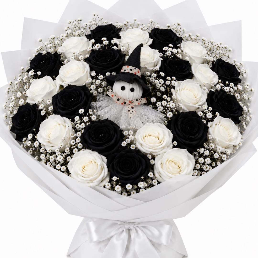 Bouquet of black and white roses with a small witch doll in the center