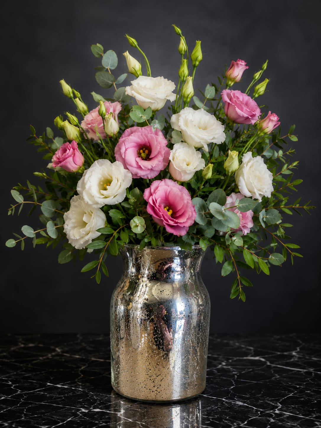Pink and white lisianthus bouquet in a silver vase
