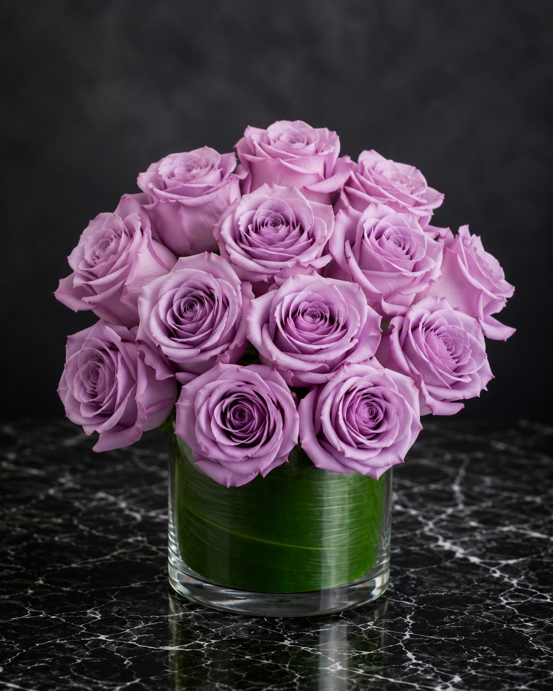 Lavender rose bouquet in a clear glass vase