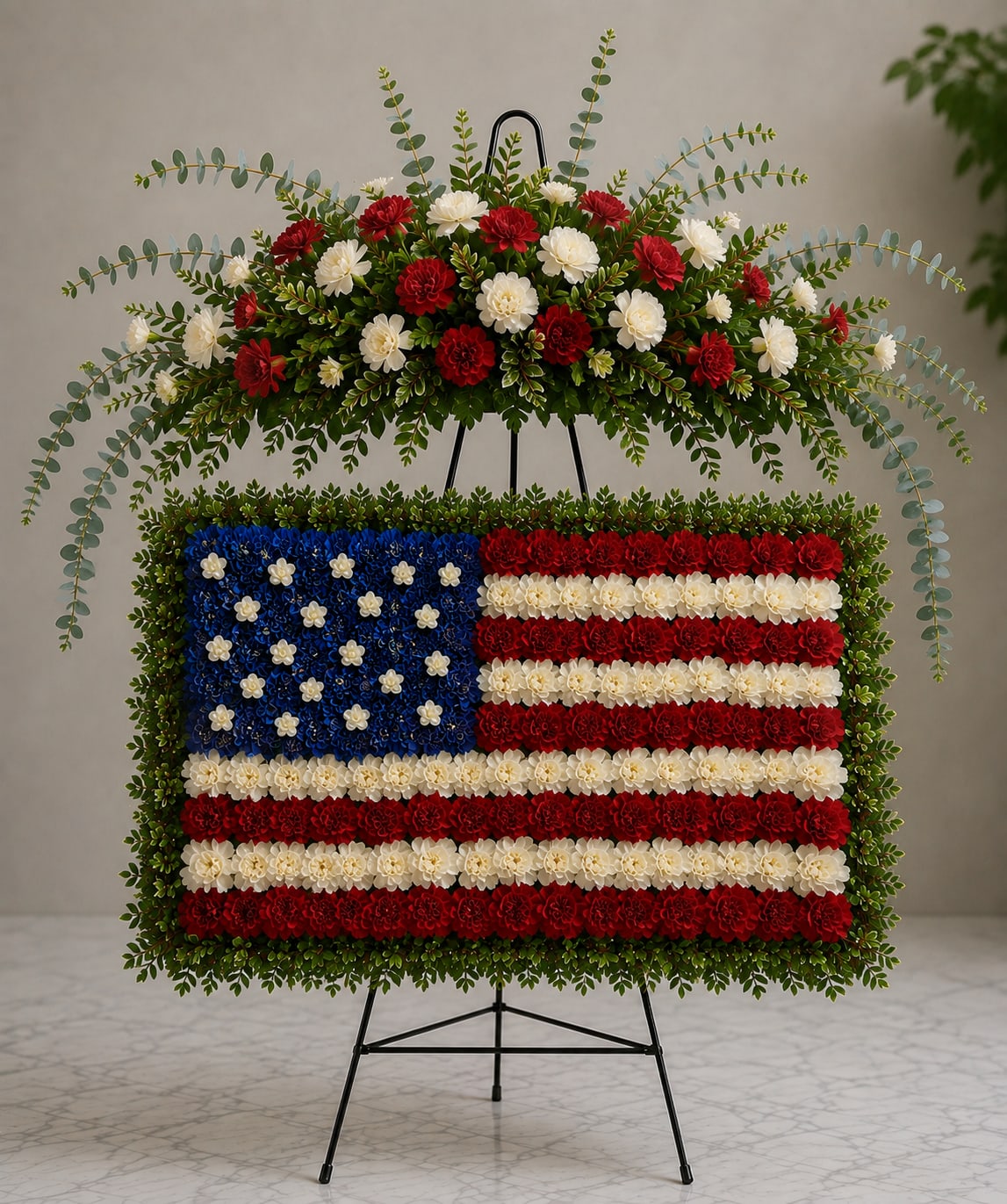 Standing floral tribute shaped like the U.S. flag on an easel