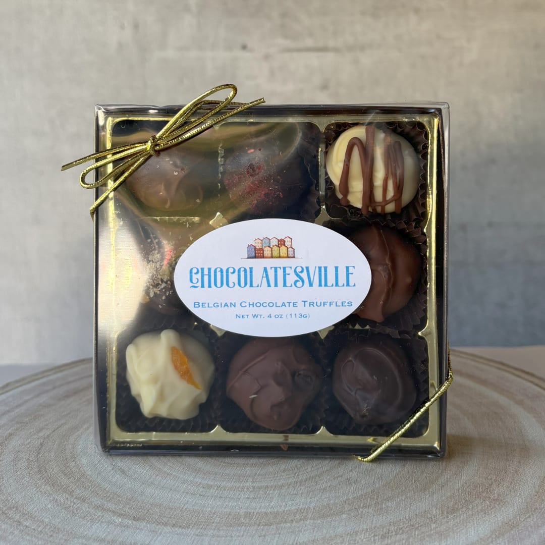Box of assorted chocolate truffles tied with a gold ribbon