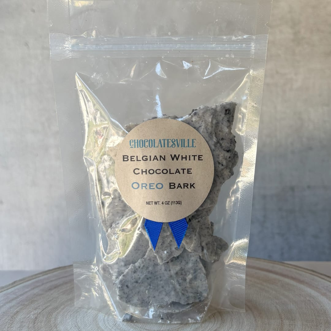 Bag of Belgian white chocolate Oreo bark with a label and blue ribbon