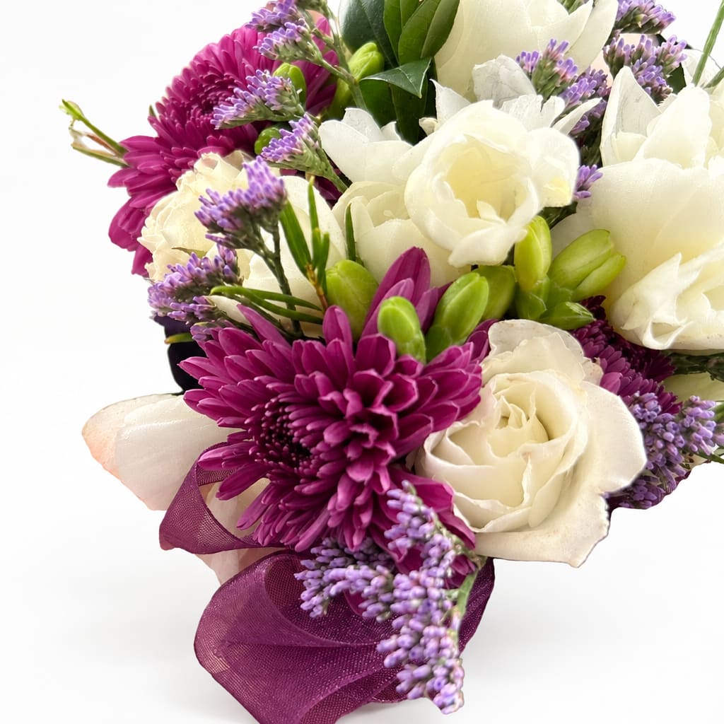 Bouquet of white roses, purple daisies, and lavender filler flowers