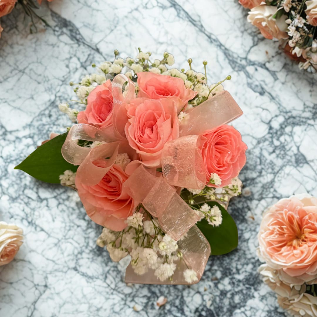 Coral rose bouquet with baby's breath and a sheer pink ribbon