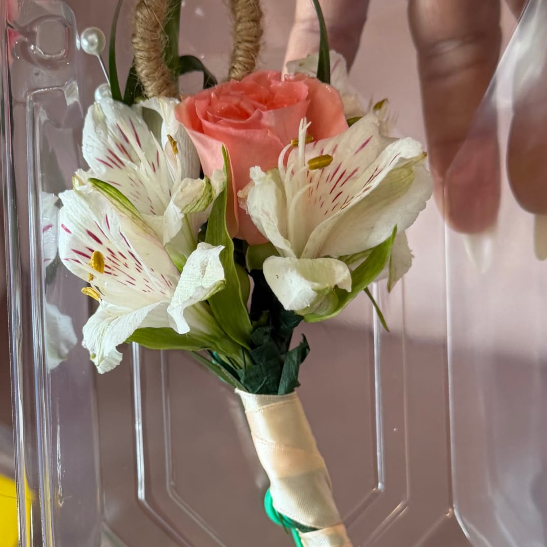 Small bouquet with a pink rose and white striped flowers, wrapped in ribbon