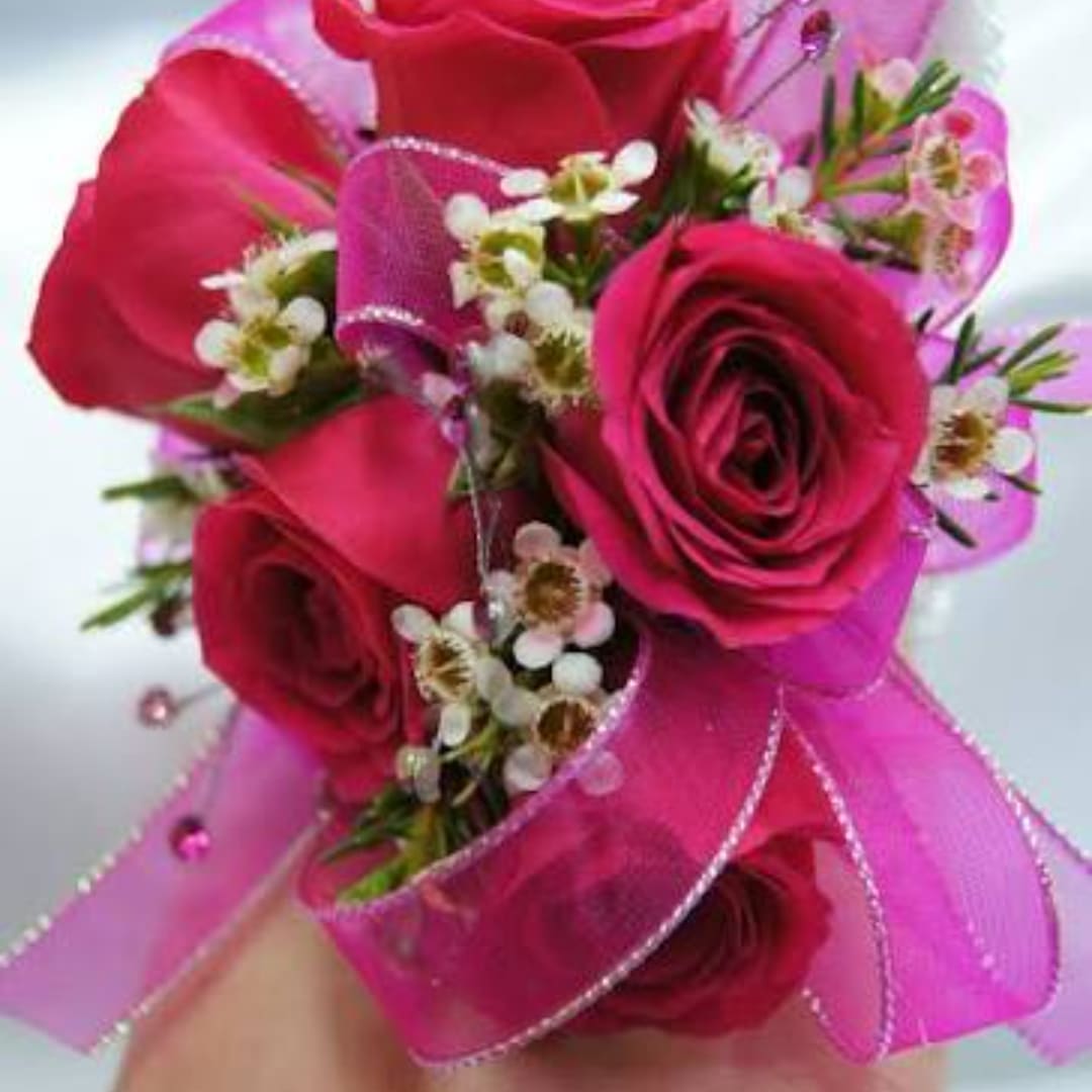 Small pink rose bouquet with ribbon and tiny white filler flowers