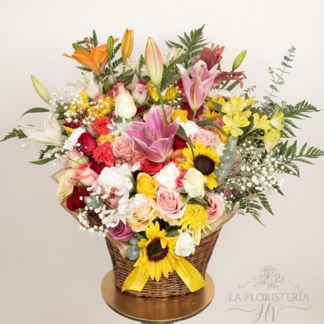 Mixed bouquet in a wicker basket with lilies, roses, and sunflowers