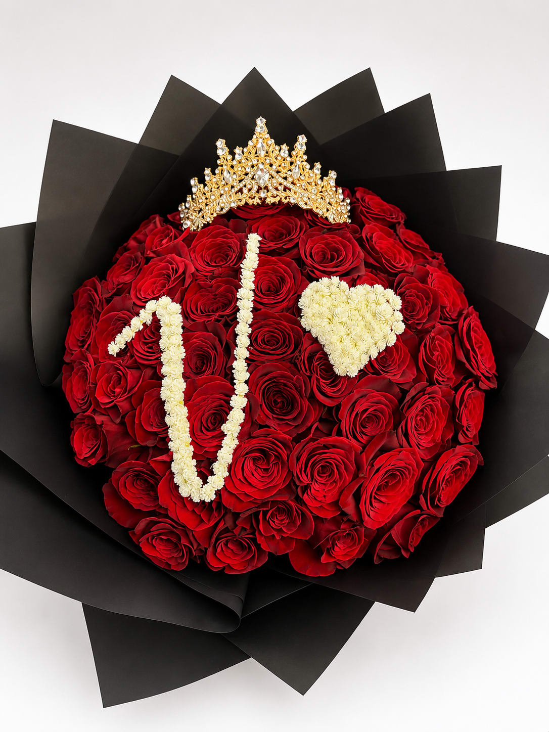 Red rose bouquet with a gold crown and white floral lettering