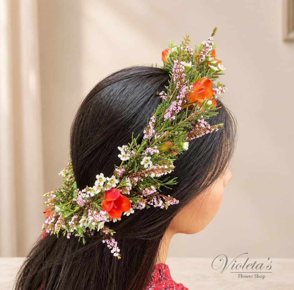 Woman wearing a floral crown with orange and white blossoms