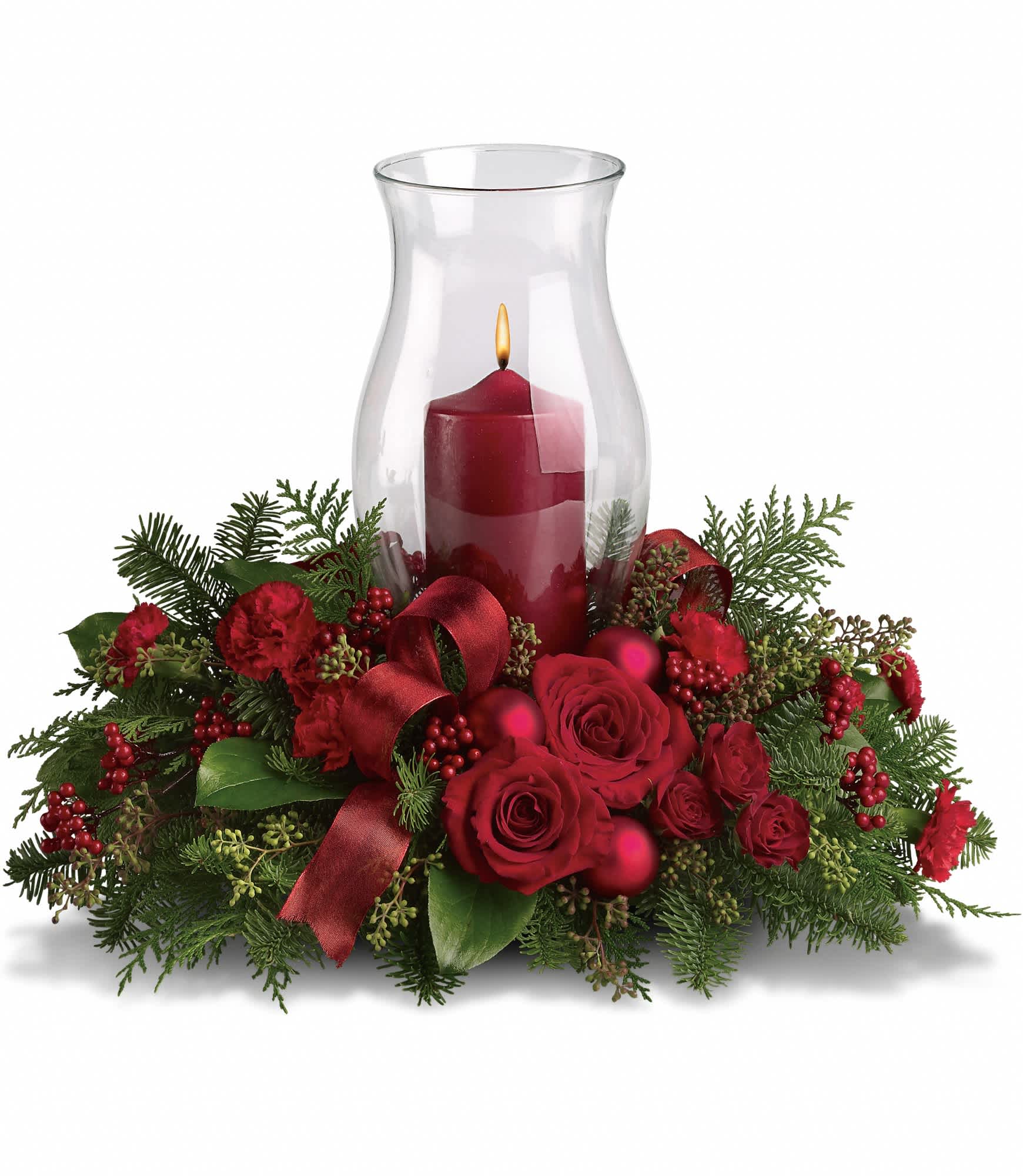 Holiday Glow Centerpiece - Glow ahead and send this spectacular centerpiece to anyone who's on your Christmas list this year. A glowing hurricane candle takes center stage but the surrounding festive touches make this arrangement radiate joy.    Beautiful red roses, spray roses and carnations, white asiatic lilies, festive Christmas greenery and ornaments plus an elegant hurricane candle make this divine Christmas dÃÂ©cor.    Approximately 19" W x 15 1/2" H    Orientation: All-Around        As Shown : T115-3A      Deluxe : T115-3B      Premium : T115-3C    