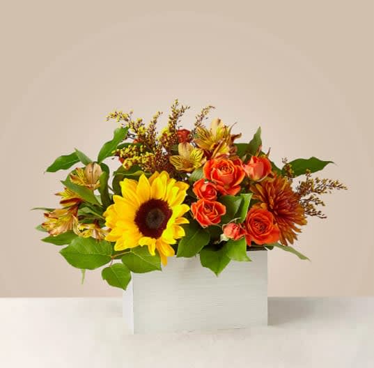 Golden Hour Bouquet - Shorter days mean less time to wait before stunning sunsets paint the horizon with amber hues like the Golden Hour bouquet. Better yet, picture having the happy sunflowers and blooming orange spray roses under the glow of autumn dusk. These flowers may even inspire you to wake up early for the dawn golden hour!  The Deluxe Bouquet is about 14"H x 18"W. 