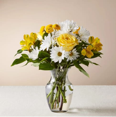 Sunny Sentiments Bouquet - Share some sunshine with your loved ones with this cheery bouquet. Designed with uplifting shades of yellow, this bouquet features classic blooms to boost their mood &amp; make any day brighter.  The Original Bouquet is approximately 12"H x 14"W.