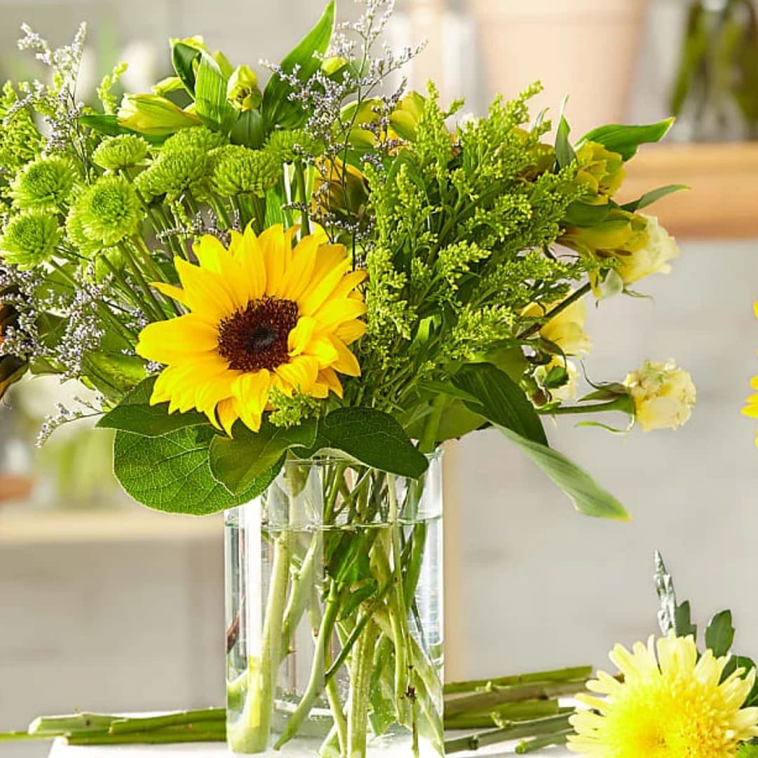 Yellow sunflower bouquet in a clear glass vase