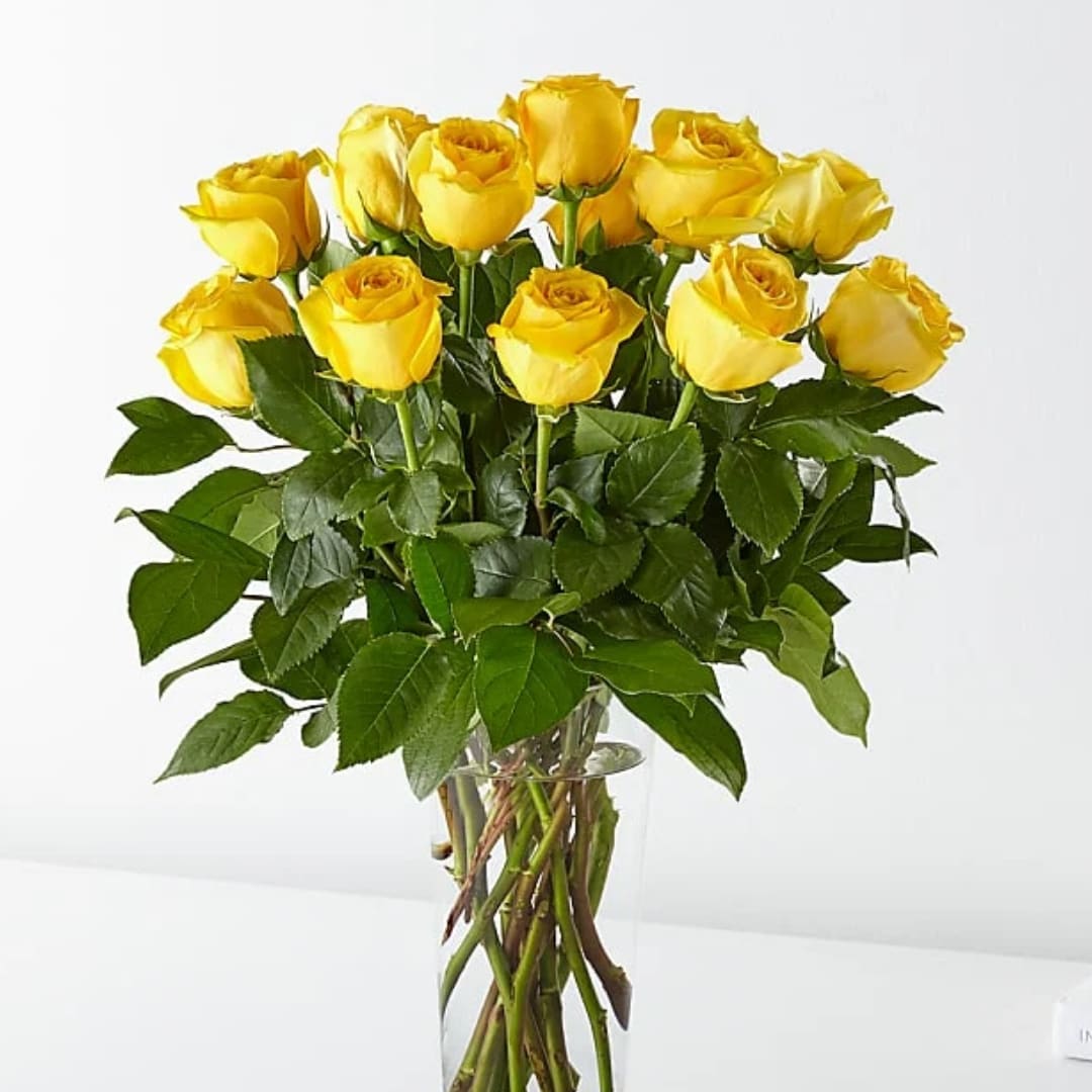 Yellow roses arranged in a clear glass vase