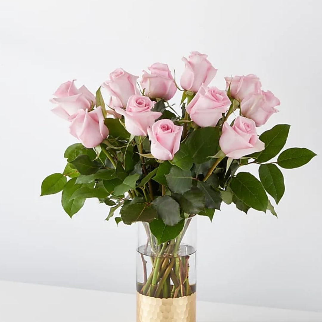 Pink roses arranged in a clear glass vase