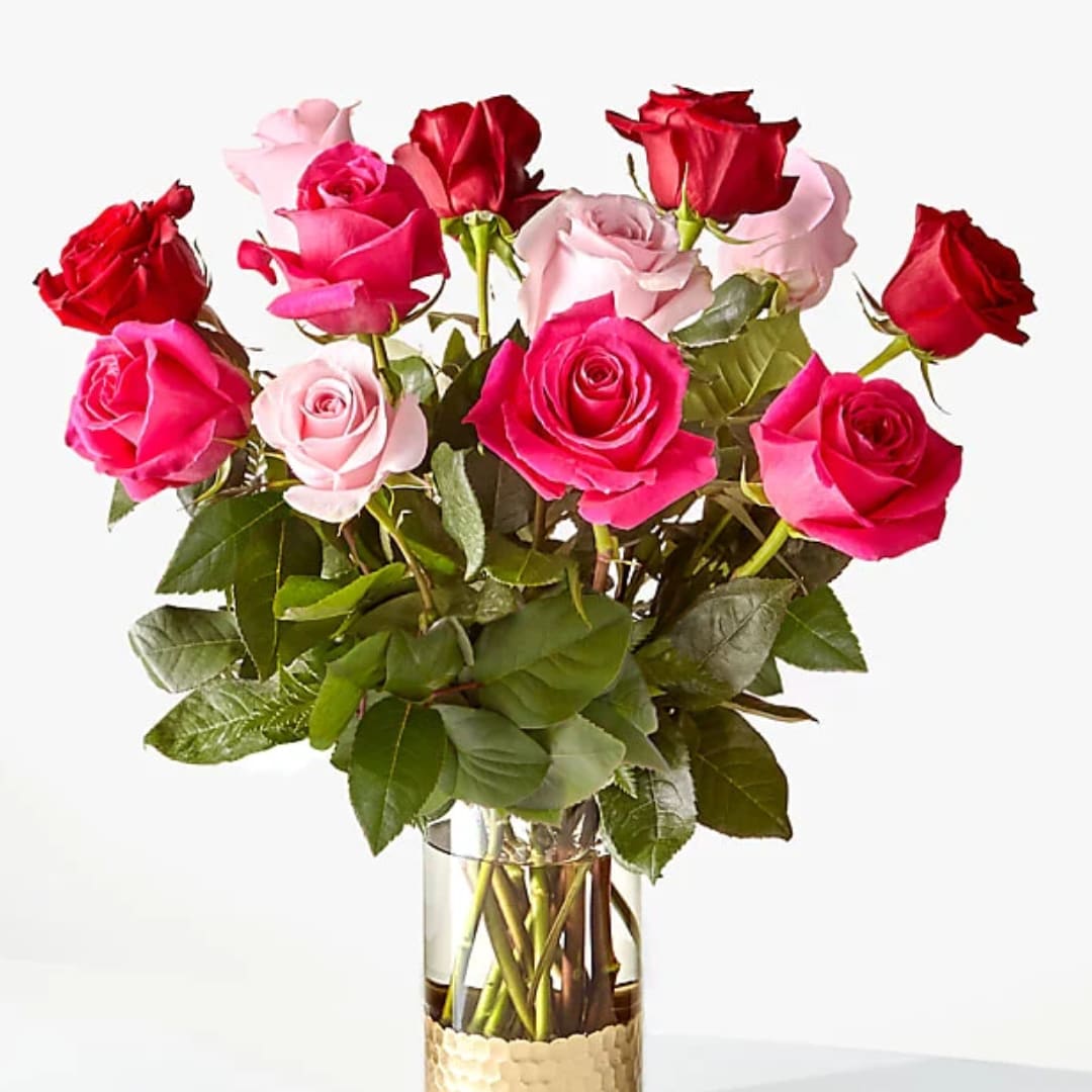 Bouquet of pink and red roses in a clear glass vase