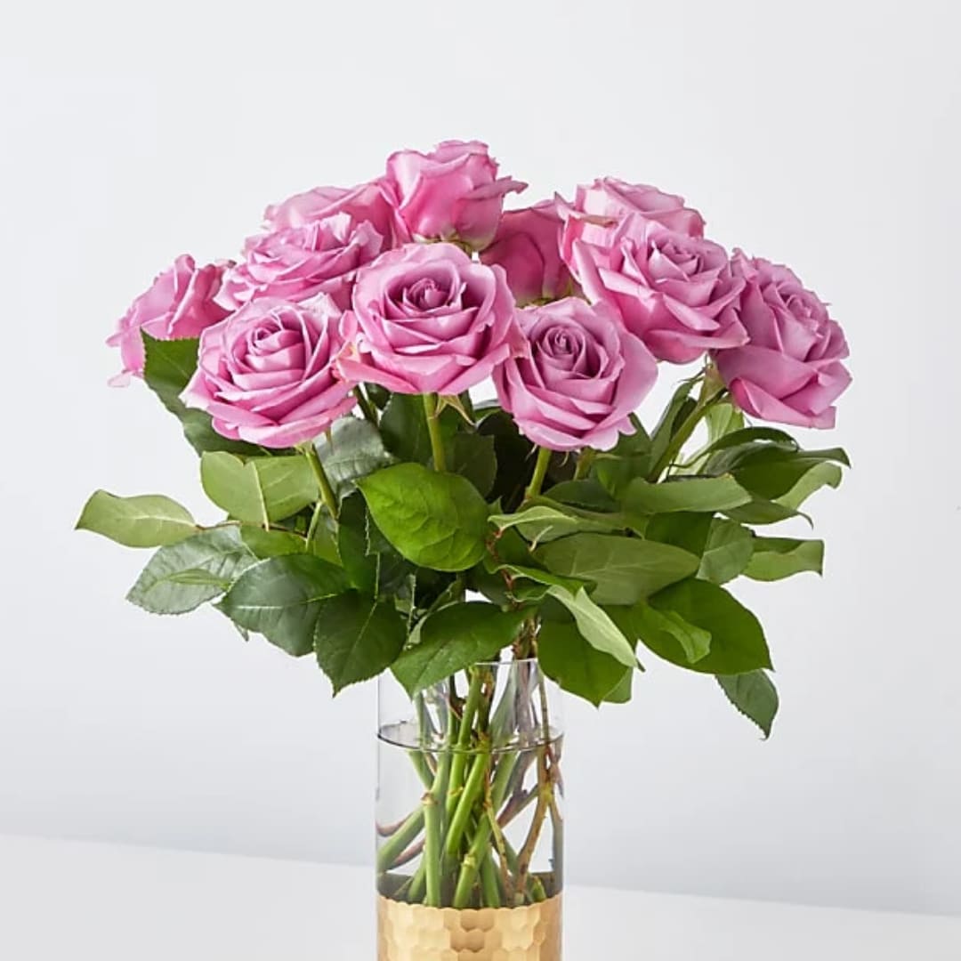 Pink roses arranged in a clear glass vase