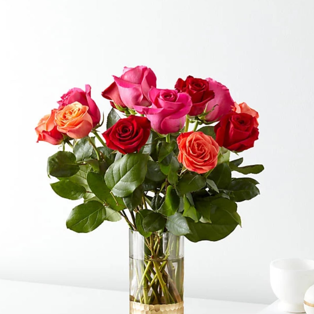 Bouquet of multicolored roses in a clear glass vase