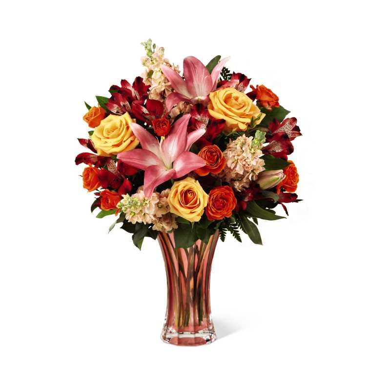 FTD Touch of Spring Bouquet - The FTD Touch of Spring Bouquet beautifully delivers the season's exuberant, sunlit promise. Lovely peach colored roses, pink Asiatic Lilies, fragrant peach gilly flower, red Peruvian Lilies, orange spray roses and lush greens combine in a refreshing bouquet arranged in a graceful peach glass keepsake vase. Makes a perfect gift for Easter, Mother's Day, graduation or to say, thank you!
