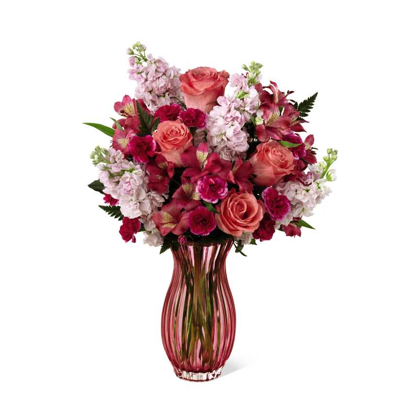 The FTD Timeless Elegance Bouquet  - The FTD Timeless Elegance Bouquet is an inspired work of floral art that blends a variety of colors from vibrant to whisper soft in a bouquet, never to be forgotten. Stunning coral roses, fragrant pink gilly flowers, fuchsia mini carnations, dark pink Peruvian Lilies and lush greens are beautifully arranged in a blushing heavy glass keepsake vase. Makes a perfect impression on Mother's Day or any day you want to express your love_birthdays, anniversaries, or for thank youÂ and get well wishes.